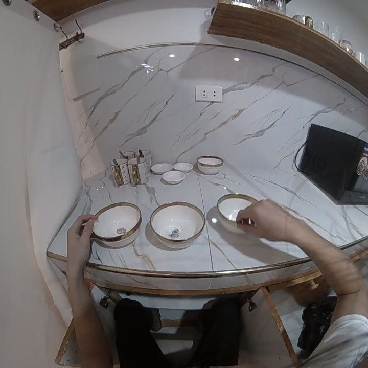 First-person kitchen cabinet organization with both hands visible