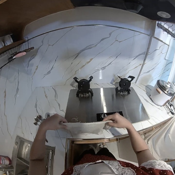 First-person stove cleaning with both hands visible